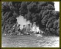 Fire and smoke pour from the battleships Arizona (right) and West Viginia (left).